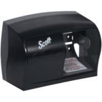 A black Scott paper towel dispenser with a clear panel for monitoring supply is wall-mounted, beside the compact Scott® Coreless Bathroom Tissue Dispenser (11W x 8H x 6D) known for its efficient and accessible design.