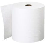 A large roll of Scott® Essential™ Plus White Hard Roll Towel (8 x 600) stands upright, partially unrolled, with its cylindrical shape revealing the inner cardboard tube, exemplifying its efficient design.