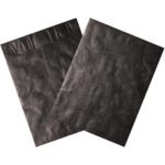 Two black 9 x 12 Black Tyvek® Envelopes (100/Case) are set against a white backdrop, with one slightly overlapping the other, highlighting their smooth and textured exteriors along with the top sealing flaps.