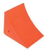 The Vestil Jumbo Urethane Wheel Chock W/Steel Studs is orange, wedge-shaped with diagonal grooves, and has a hole near the base for stability.
