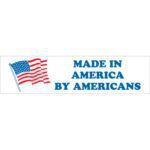 An illustration shows a waving American flag on the left and bold blue text MADE IN AMERICA BY AMERICANS on the right against a white background, resembling the MH-USA 2 x 8 labels (500/Roll) highlighting American craftsmanship.