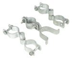 Four hinged silver metal pipe clamps, similar to those in the Vestil Pipe Safety Railing system, are displayed against a white background. Each clamp has two halves joined by bolts and nuts to securely hold pipes together and is arranged in a slightly scattered formation.