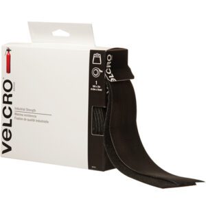 A box of 2 x 15 Black VELCRO® Brand Tape from the Combo Packs features industrial-strength hook-and-loop fasteners. The packaging is white with black text and a red Velcro illustration, and one black strip is partially pulled out.