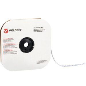 A spool of 1/2 white VELCRO® Brand hook tape for individual dots (1440/Case) unwinds from a cardboard dispenser featuring the Velcro logo and text, with a central cutout for easy dispensing.