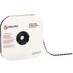 A roll of 3/4 black VELCRO® Brand hook-and-loop tape is unwound, sitting in a square dispenser with a central circular spool. Its white packaging features the Velcro logo and details, offering individual dots (1028/case) for versatile use.