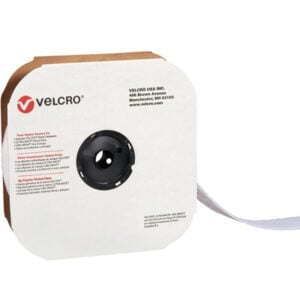 The 2 x 75 white VELCRO® Brand Tape, designed for creating individual strips, comes in a cardboard dispenser box with a black circular cutout and iconic logo. The tape is partially unrolled from the right side for easy access.
