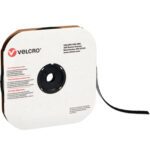 A roll of 1/2 x 75 Black VELCRO® Brand Hook Tape, with the end slightly pulled out, rests in a square cardboard box featuring the Velcro logo and details in bold red and black text.