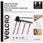 The 1 x 50 White VELCRO® Brand Tape Combo Pack features sleek black and white packaging, highlighting product details in English, Spanish, and French. Images show its industrial strength for holding brooms or caution signs, with dimensions prominently displayed at the top.