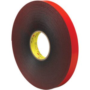 A 1 x 5 yds. roll of Gray 3M™ 4611 VHB™ Tape is displayed edge-up, showing black foam with a red backing. The encased tape with a textured look winds tightly around a yellow core featuring printed text, highlighting its versatile adhesive properties.