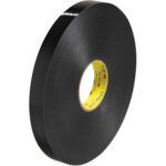 A large roll of 1 x 5 yds. Black 3M™ 4929 VHB™ Tape (1 Roll/Case) with a yellow core shines on a plain white background, emphasizing its glossy, smooth surface.