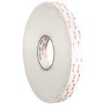 The 1/2 x 5 yds. White 3M™ 4930 VHB™ Tape (1 Roll/Case) features a clear center, red 3M logo, and double-sided adhesive, ideal for secure and easy item fastening.