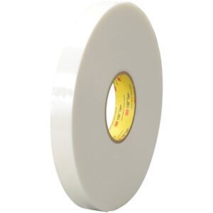 A 1 x 5 yds. roll of white 3M™ 4951 VHB™ tape, featuring a yellow and red core label, stands upright against a simple backdrop.