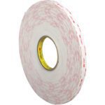 A partially unwound roll of 1/2 x 5 yds. White 3M™ 4955 VHB™ Tape (1 Roll/Case) with a white surface and red brand imprint is visible.
