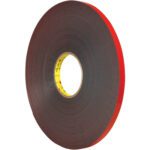 This 1 x 5 yds. Dark Gray 3M™ 5925 VHB™ Tape comes in a large roll with a red liner and brand logo on the core, offering durable, double-sided adhesive ideal for various uses.