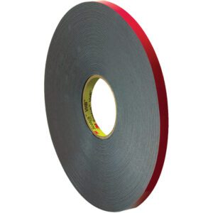 The 3M™ 5958FR VHB™ Tape, sized at 1/2 x 5 yds., features a red edge and a core with bold yellow and red text. This black tape, perfectly wound in a circular shape, is ideal for various industrial and household uses.