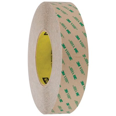 VHB946001R.jpg A roll of 1 x 5 yds. Clear 3M™ F9460PC VHB™ Tape is showcased upright, highlighting its circular form and adhesive interior with brown paper backing and green text, underscoring its quality as an essential tool.