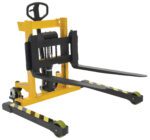 The Vestil Stacker Manual Pump 2-35 In 3000 Lb features a yellow design with black and green wheels, adjustable forks, and a hydraulic lifting mechanism. Its perfect for maneuvering pallets in warehouses, handling up to 3000 lbs with a lift range of 2-35 inches.