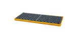 The Vestil Ultra Spill Deck Two Drum Flexible black mat features a grid-textured, non-slip surface for two drums. Its yellow border is eye-catching against a white background, enhancing both safety and style.