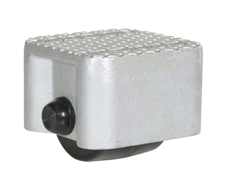 VPRDO-1_A.jpg A close-up of a metallic gray pedal features a textured surface similar to the durability of the Vestil Cast Aluminum Dolly 1500 Lb 4.5L X 4.5W, with a black rubber pad underneath and a circular part for attachment, likely designed for a bicycle or similar vehicle.