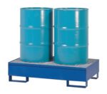 Side by side, two blue industrial barrels rest on a Vestil Vertical Drum Retention Basin 34X54X18, which has a grated top and sturdy legs. The metallic sheen of the upright barrels contrasts against the plain white background.