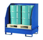 Two large green barrels sit on a wooden pallet within a 1200 lb Vestil Retention Basin-Separation Walls unit, designed for catching leaks or spills.