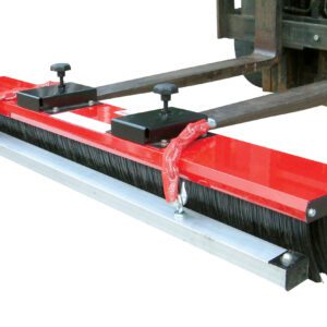 A red industrial broom attachment from the Vestil Valusweep Series Magnet 5 Foot is secured to a forklift. It includes two clamps and rows of black bristles for efficient large-area sweeping.