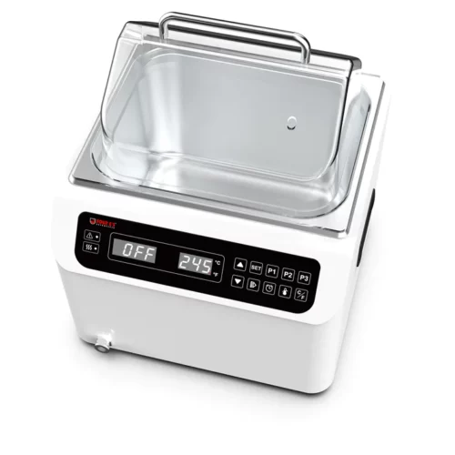 A digital sous vide cooker with a transparent lid, a metal handle, and a digital display showing OFF and 24.5°C. The control panel has various buttons for settings and a temperature gauge. The device is white with a compact design.