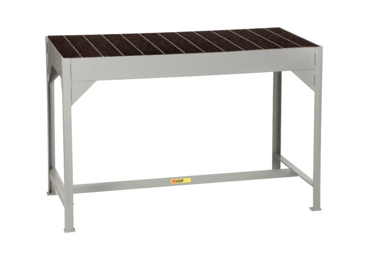 The Little Giant Welders Table features a robust metal grating surface, ensuring durability for heavy-duty tasks. Supported by four sturdy gray legs, its functional design is enhanced by a small yellow label on the front.