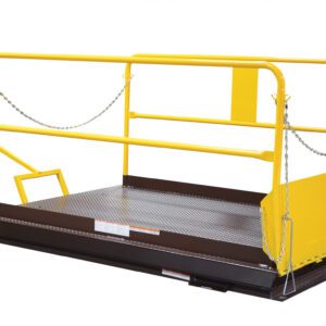 A person in blue overalls operates a lift platform with yellow rails and a handle. The platform, featuring protective chains and safety barriers, includes the Vestil Dock Lift Optional Mobile Wheel Kit for better mobility on its diamond-patterned metal surface.