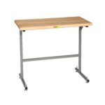 A wooden-top table with a metal frame and four small feet, reminiscent of the Little Giant Stand Up Workstation with Butcher Block Top. The gray frame pairs elegantly with the light brown butcher block top, offering a simple, minimalist design for various settings.