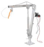 The Vestil Winch Operated Truck Jib Crane - Galv Dc boasts a steel design with a pivoting arm, winch, and red/black cables. Labeled 500 LBS, it includes a safety strap and mounting base for secure lifting.