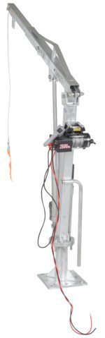 The Vestil Winch Operated Truck Jib Crane - Galv Dc is a durable metal hoist with a winch and cables, mounted on a base. It has labeled 2500 lbs capacity, equipped with levers, and features a lifting hook at the cables end.