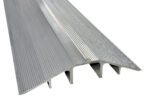 A close-up of a metallic structure with a ribbed, corrugated surface, akin to the Vestil Extruded Alum Hose/Cable Crossover 60. The design features parallel ridges and grooves, highlighting its durable and industrial aesthetic.