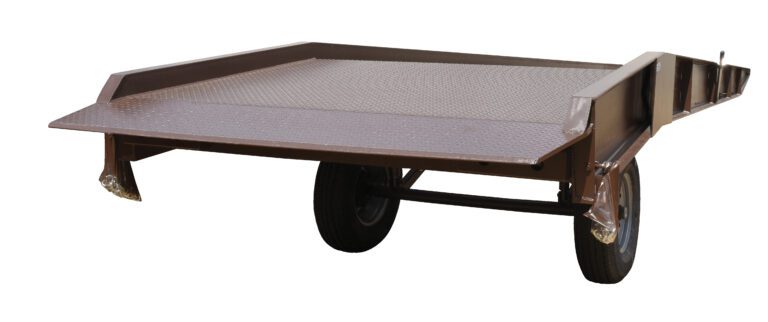 The brown flatbed utility trailer with a diamond plate surface features the Vestil Steel Yard Ramp Overlap Style 30K 85X36 design, offering a two-wheel configuration and flat loading area for securely transporting goods or equipment when attached to a vehicle.