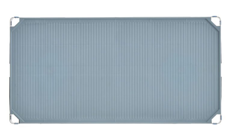 The MetroMax i MX1836F Plastic Industrial Shelf with Solid Mat, sized at 18 x 36, features a rectangular, ribbed light blue tray with rounded corners and small metal hooks at each corner for versatile storage.