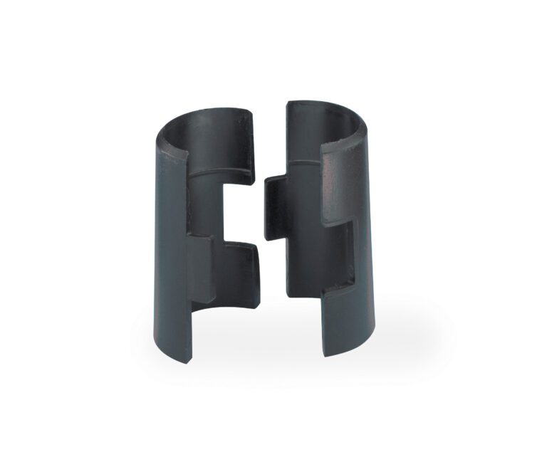 The image shows a black, cylindrical Metro 9985 Replacement Plastic Split Sleeve for Super Erecta Industrial Wire Shelving, from the pack of 4, divided into two equal halves. Each half has a central notch resembling a clamp or bracket and is upright on a white surface.