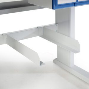 Close-up of a metal workstation frame with a grey finish. It features a sturdy horizontal support bar and vertical legs. Above, there is a blue storage drawer partially visible. The surface is clean and industrial.