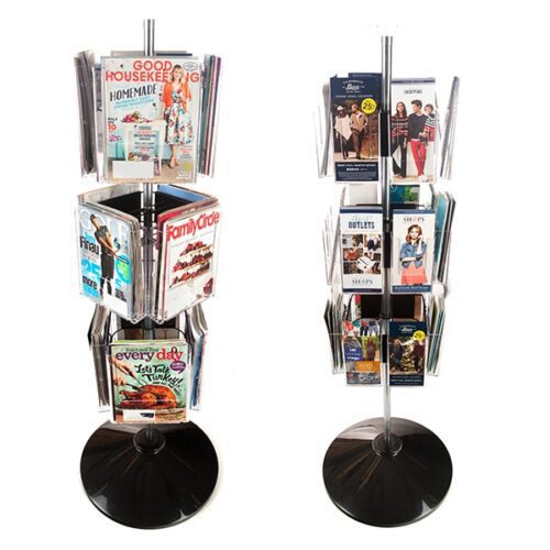 Two metal floor stands with black bases display magazines. The left stand features Family Circle and Good Housekeeping. The right uses Vulcan CIRC 12 CLEAR 11 POCK 3 ROTATORS for shopping brochures. Each stand is multitiered.