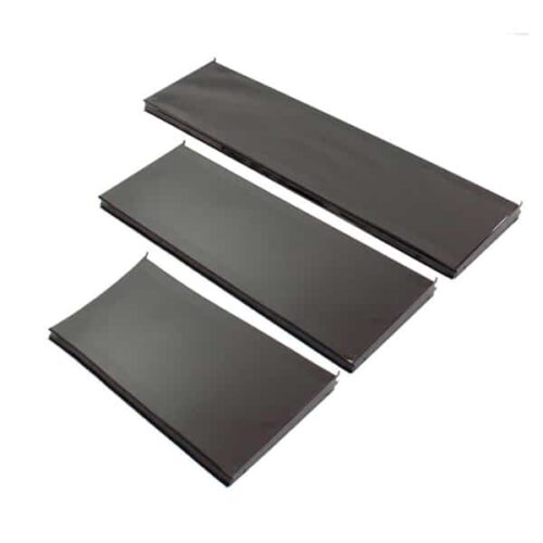 Three elongated, rectangular black trays of varying sizes, similar in design to the Vulcan SP SHELF 24 X 12 BLACK, are aligned parallel against a plain white background with the smallest on top and the largest at the bottom.