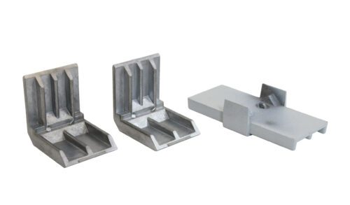 Three metal L-brackets are displayed against a white background. Two brackets are upright with ridged surfaces, while the third laid flat has a rectangular shape with extending tabs on either side. They appear to be industrial components.