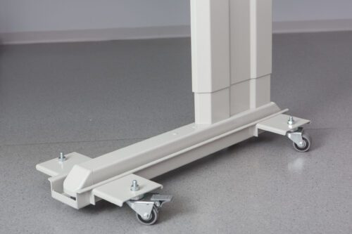 Close-up of a white, adjustable hospital bed base on a grey floor. The base has four wheels with locks, allowing mobility and stability. The design is sleek and functional, suitable for medical environments.