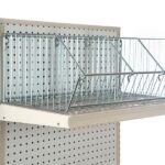 The Vulcan WIRE BASKET 12 X 24 OEB (8 per carton) is mounted on a perforated board display unit. These baskets, divided into compartments, are ideal for organizing and shelving items in retail or storage settings.