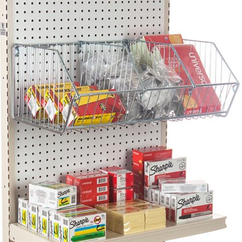 A store shelf displays office supplies featuring Vulcan WIRE BASKET 12 X 24 OEB baskets with boxes of rubber bands and other items, while the lower shelf holds packs of sticky notes, Sharpies, and index cards. Packaging is vibrant, with distinct brand names clearly visible.