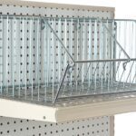 A Vulcan WIRE 12 OEB DIVIDE from a carton of 10 is stylishly displayed on a pegboard shelf. Crafted with sleek metal rods, it provides visibility and ventilation for items. The adjustable pegboard ensures versatile storage solutions.