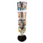 The Vulcan CIRC 16 3/4 POCK 4 ROTATORS elegantly spins on a stand with four rotators, showcasing colorful magazines in vibrant tiers on a sturdy round black base.