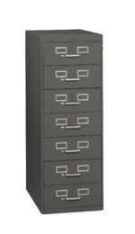 A tall, gray metal filing cabinet with seven drawers, each featuring a label holder and handle. The cabinet has a lock near the top right corner. The design is simple and functional.