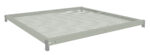 A rectangular, metal mesh panel is shown, framed by a solid border. The mesh consists of small, evenly spaced circular holes. The panel appears to be part of a shelving or storage system. The color is a light, neutral gray.