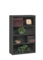 A black bookshelf with three shelves. It holds decorative items, including two sets of books with red and black covers, two decorative plates, a green plant, and a small leafy arrangement on the bottom shelf.