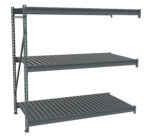 A gray industrial metal shelving unit with three horizontal shelves and vertical support beams. The shelves have a slatted design, suitable for storage or organizational purposes. The unit is isolated on a white background.