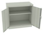 A light gray metal storage cabinet with two open doors. It features an adjustable middle shelf, providing two spacious compartments for storage. The cabinet is set on a plain white background.